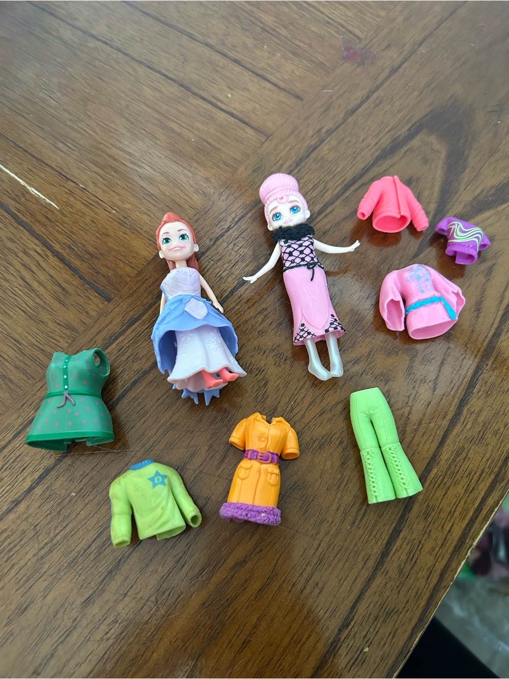 Two Polly pocket dolls with clothes